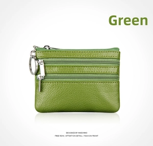 Detail of green pebble leather coin purse with three zipper compartments and key ring