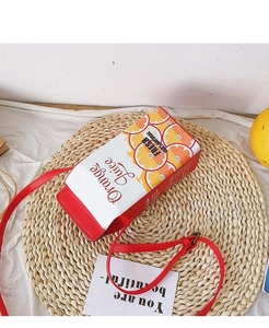 Detailed close-up of a creative orange juice box shape crossbody bag with a red strap
