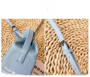 Close-up of light blue crossbody phone bag with leather texture and metal buckle detail