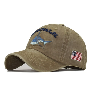 Detail of washed khaki baseball cap with shark embroidery and US flag patch details