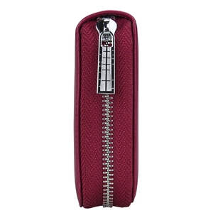 Side view of wine red leather passport wallet showing zip closure and textured fabric material