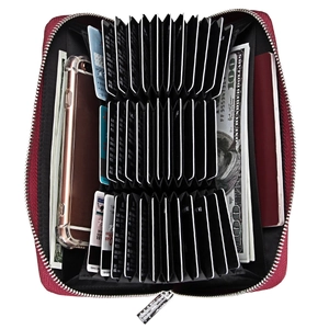 Detail of red leather accordion wallet showing multiple card slots and passport compartment