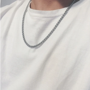 Close-up of hip hop style silver stainless steel dragon bone chain necklace on a model