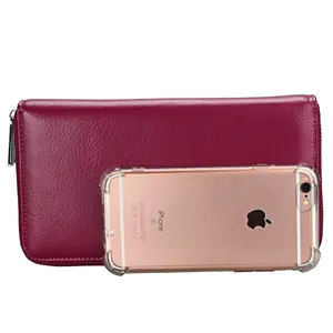 Detailed view of pink pebble leather long wallet next to an iPhone for size reference