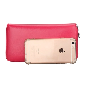 Detailed view of long rose pink leather wallet with zipper beside phone for size reference