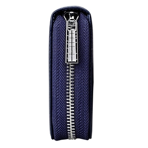 Detail view of smooth silver metal zipper and precise stitching on navy blue leather wallet