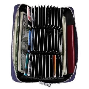 Deep purple leather accordion travel wallet holding cash, cards, and a passport