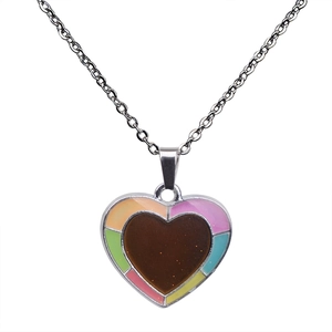 Detail of a rainbow heart pendant necklace featuring vibrant multi-colored edge and silver chain