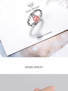 Detailed macro view of 925 silver ring with pink crystal and heart-shaped hollow patterns