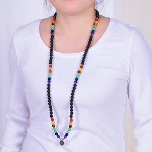 Detailed shot of 108 lava stone prayer beads with colorful accents and Buddha charm