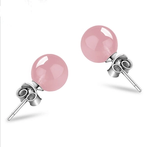 Detailed macro view of S925 silver stud earrings with round pink crystal gemstones