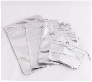 Detailed view of five silver drawstring gift bags in various sizes with woven texture