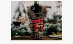 Front view of Christmas wine bottle cover with red plaid fabric and faux fur collar