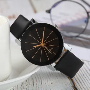 Close-up of black leather watch with golden radiating dial and quartz movement detail
