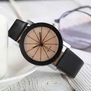 Close-up of minimalist quartz watch with leather strap and crystal accents on office desk