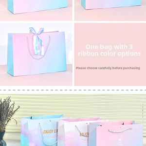 Detail of gradient gift bags with three ribbon options and silver braided handles