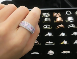 Close-up of wide multi-row micro-pave band ring with colorful macaron cubic zirconia