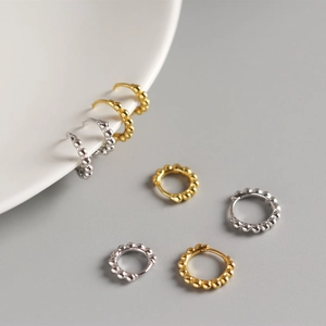 Detailed view of S925 silver beaded hoop earrings in gold and silver finish