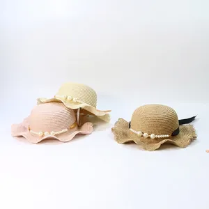 Kids woven straw sun hats with wavy brims and pearl ribbon straps in three colors