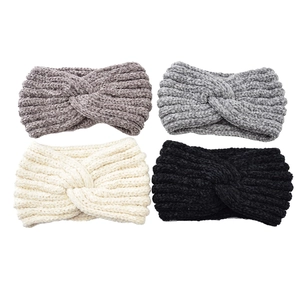 Detail of four knit headbands in grey, beige and black with thick woven texture