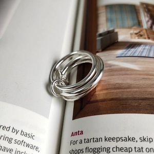 Minimalist 925 sterling silver multi-layered interlocking ring set on fashion magazine