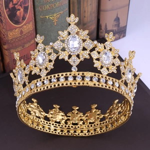 Baroque gold bridal crown with crystals on vintage books background for weddings