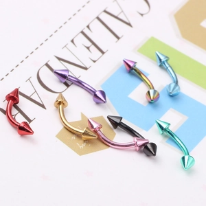 Macro shot of assorted multi-colored stainless steel curved spike studs in 8 metallic tones