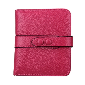 Detailed view of rose red pebble leather wallet with dual snap button closures