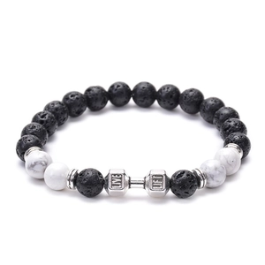 Detail of lava rock beads and white stone bracelet with silver barbell charm