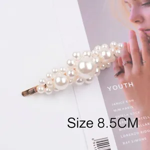 Detail showing an 8.5cm elegant pearl hair clip with gold metal base and white beads