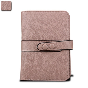 Macro view of dusty pink genuine leather wallet showing litchi grain and snap closure