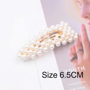 Detail of 6.5cm rectangle pearl hair clip with gold metal base on magazine background
