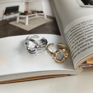 Detailed view of gold and silver S925 sterling silver rings on a magazine