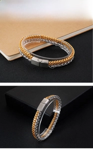Detail view of dual-tone braided stainless steel chain bracelet with matte buckle