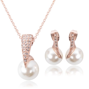 Macro shot of rose gold pearl jewelry set including necklace pendant and stud earrings