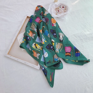 Detail of dark green silk scarf featuring hand-drawn cat illustrations and farm cat text