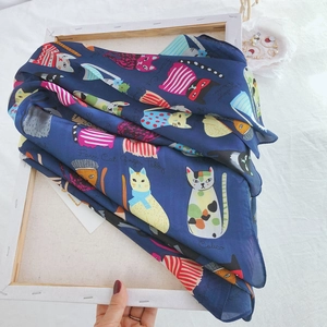 Detail of navy blue cat print silk scarf on a white frame featuring Ginger Tabby pattern
