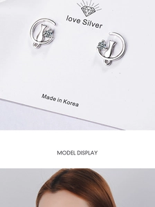 Detail of silver cat stud earrings with sparkling crystals shown on card and worn by model