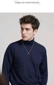 Detail of interlocking silver rings pendant on a fine chain worn over a dark turtleneck