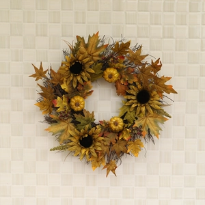 Autumn wreath with sunflowers, maple leaves and mini pumpkins for Thanksgiving home decor