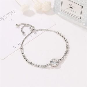 Silver adjustable bracelet with cubic zirconia and slide clasp on a gift-themed background