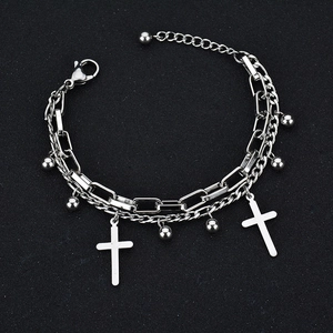 Double-layered stainless steel chain bracelet with cross pendants on black background