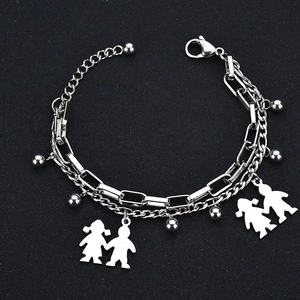 Close-up of double-layered silver steel bracelet with tree of life and figure charms