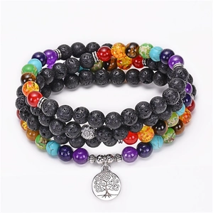 Detail of 108 lava stone chakra beads with silver tree of life charm and lotus accents