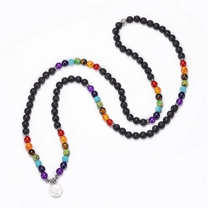 Detailed view of 8mm lava stone beads and silver Tree of Life pendant on a chakra necklace