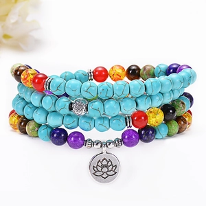 Detailed macro view of 108 turquoise beads multi-layer bracelet with silver lotus charm
