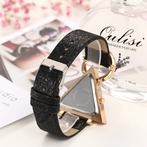Detailed macro view of the stainless steel back and glitter strap on a women's watch