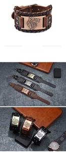 Detail view of men's leather bracelet with vintage wolf head metal charm and braided edges