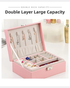 Macro view of double-layer pink leather jewelry box showing necklace hooks and ring slots