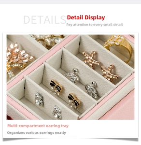 Close-up of double-layer pink leather jewelry box with multi-slot earring organizer panel